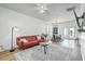 Bright living room featuring hardwood floors, a stylish red couch, and a ceiling fan at 107 Amaranth Ave, Summerville, SC 29483