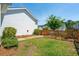 Beautiful backyard with green lawn, wooden fence, and lush landscaping at 112 Starling St, Summerville, SC 29483