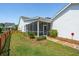 Well-kept backyard featuring a screened porch, green lawn and a stone walkway at 112 Starling St, Summerville, SC 29483