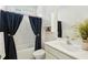 Bright bathroom featuring a modern sink, white cabinets and a bathtub with a unique curtain at 112 Starling St, Summerville, SC 29483