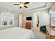 Spacious bedroom with a cozy accent chair, ensuite bath access, and a ceiling fan for added comfort at 112 Starling St, Summerville, SC 29483