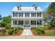 Stunning two-story home with black shutters, inviting front porch and meticulous landscaping at 112 Starling St, Summerville, SC 29483