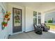 Inviting front porch with comfortable seating, stylish decor and a decorative wreath at 112 Starling St, Summerville, SC 29483