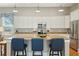 Kitchen island with granite countertop, seating for four, stainless steel appliances, and ample cabinet space at 112 Starling St, Summerville, SC 29483