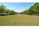 Expansive green lawn leading to a tranquil lake, providing a peaceful community space to relax at 112 Starling St, Summerville, SC 29483