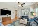 Comfortable living room with hardwood floors, ceiling fan, large windows, and access to an outdoor patio at 112 Starling St, Summerville, SC 29483
