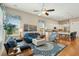 Cozy living room showcases a plush navy sofa, patterned rug, and open layout with view into the kitchen at 112 Starling St, Summerville, SC 29483