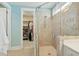 Bathroom featuring glass shower, access to walk-in closet, and neutral tile at 112 Starling St, Summerville, SC 29483