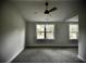 This bedroom features carpet and two windows that provide natural light, creating a warm and inviting space at 1178 Braddock Ave, North Charleston, SC 29406