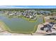 Stunning aerial view of homes nestled around a picturesque lake community with lush green landscaping at 118 Jesup Ct, Ridgeville, SC 29472