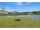 Backyard featuring a fire pit and views of the lake and neighborhood at 118 Jesup Ct, Ridgeville, SC 29472