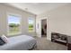 Bedroom featuring a view of the lake, large windows, and closet access at 118 Jesup Ct, Ridgeville, SC 29472