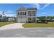 Charming two-story home with a front porch, two-car garage, basketball hoop, and a well-manicured lawn at 118 Jesup Ct, Ridgeville, SC 29472