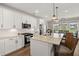 Kitchen featuring stainless appliances, granite countertops, white cabinetry, and an island with seating at 118 Jesup Ct, Ridgeville, SC 29472
