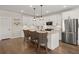 Open concept kitchen with stainless steel appliances, hardwood floors, granite counters, and barstool seating at 118 Jesup Ct, Ridgeville, SC 29472