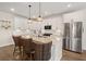 Bright kitchen featuring stainless steel appliances, granite countertops, white cabinets, and barstool seating at 118 Jesup Ct, Ridgeville, SC 29472