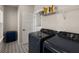 Functional laundry room with modern appliances, patterned floors, and ample storage space at 118 Jesup Ct, Ridgeville, SC 29472
