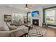 Comfortable living room with a fireplace, large windows, and stylish furniture, perfect for relaxation at 118 Jesup Ct, Ridgeville, SC 29472