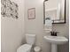 Stylish powder room featuring a modern vanity, decorative mirror, and elegant fixtures at 118 Jesup Ct, Ridgeville, SC 29472