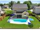 Aerial view of a backyard with a sparkling pool, lounge chairs, and a screened patio at 118 Netherfield Dr, Summerville, SC 29486