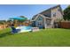Spacious backyard with a pool, patio furniture, lush green lawn, and privacy fence at 118 Netherfield Dr, Summerville, SC 29486
