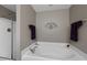 Bathroom with white walls, large tub, dark towel decoration, and stand up shower with glass doors at 118 Netherfield Dr, Summerville, SC 29486