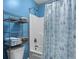 Bright blue bathroom with nautical accents, shower and storage racks at 118 Netherfield Dr, Summerville, SC 29486