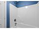 Clean and simple bathtub and shower featuring white tiling and modern fixtures against a blue wall at 118 Netherfield Dr, Summerville, SC 29486