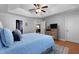 Light-filled bedroom features hardwood floors, a ceiling fan, and comfortable bed with an ensuite bathroom at 118 Netherfield Dr, Summerville, SC 29486