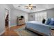 Light bedroom features hardwood floors, ceiling fan, plantation shutters, and comfortable bed at 118 Netherfield Dr, Summerville, SC 29486
