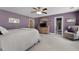 Spacious bedroom features purple walls, ceiling fan, and ensuite bathroom for comfortable living at 118 Netherfield Dr, Summerville, SC 29486