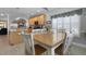 Bright dining area features a wooden table, six white chairs, plantation shutters, and ample natural light at 118 Netherfield Dr, Summerville, SC 29486