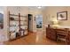 Inviting hallway with hardwood floors, decorative shelving, and desk area leading to the bedroom at 118 Netherfield Dr, Summerville, SC 29486