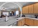 Kitchen with sink, dishwasher, bar top, and light wood cabinets overlooking the living room at 118 Netherfield Dr, Summerville, SC 29486