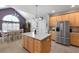 Open kitchen with island, stainless appliances, and tile floors leading to the dining area at 118 Netherfield Dr, Summerville, SC 29486