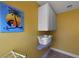 Practical laundry area with white cabinets, a laundry basket, and decorative art at 118 Netherfield Dr, Summerville, SC 29486