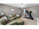 Comfortable living room with green leather sofa, fan, art, and exercise equipment at 118 Netherfield Dr, Summerville, SC 29486