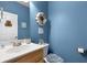 Powder room boasts blue walls, seashell decorations, and a stylish vanity with modern fixtures at 118 Netherfield Dr, Summerville, SC 29486