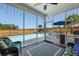 Relaxing screened porch with wicker seating, a rug, and a view of the backyard pool and fence at 118 Netherfield Dr, Summerville, SC 29486