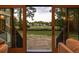 View from inside the home, showcasing views of the golf course and natural light through the large patio doors at 1183 Farm Quarter Rd, Mount Pleasant, SC 29464