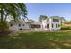 Large backyard with expansive lawn, modern architectural details, and mature shade trees at 1183 Farm Quarter Rd, Mount Pleasant, SC 29464