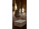 Close-up on a marble sink with gold fixtures and sconces at 1183 Farm Quarter Rd, Mount Pleasant, SC 29464