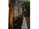 The exterior of this home features a stone walkway, mature landscaping, and accent lighting at 1183 Farm Quarter Rd, Mount Pleasant, SC 29464