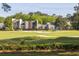 Townhomes with manicured lawns overlook the green golf course, combining residential charm with recreational beauty at 1183 Farm Quarter Rd, Mount Pleasant, SC 29464
