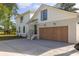 Exterior view showcasing the garage, brick facade, and white siding of the home at 1183 Farm Quarter Rd, Mount Pleasant, SC 29464
