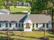 Front exterior of the home with fresh landscaping, large lawn, brick and modern architectural details at 1183 Farm Quarter Rd, Mount Pleasant, SC 29464