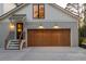 Exterior view of the attached garage with a wooden door and a staircase with metal railings at 1183 Farm Quarter Rd, Mount Pleasant, SC 29464