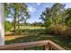 View from the balcony overlooking the golf course with mature trees and beautiful landscaping at 1183 Farm Quarter Rd, Mount Pleasant, SC 29464