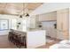 Modern kitchen with large island, wooden stools, and stainless steel appliances at 1183 Farm Quarter Rd, Mount Pleasant, SC 29464