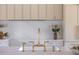 Modern kitchen with gold hardware, light colored cabinets, quartz backsplash, and a deep basin sink at 1183 Farm Quarter Rd, Mount Pleasant, SC 29464